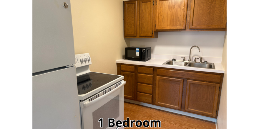 a kitchen with a refrigerator, stove and sink