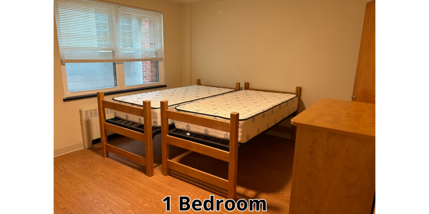 a bedroom with a bed and a desk in it