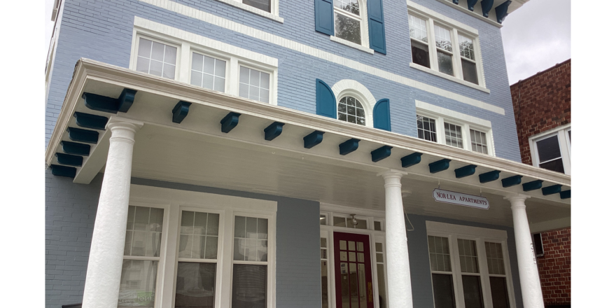 a blue and white house with columns and windows