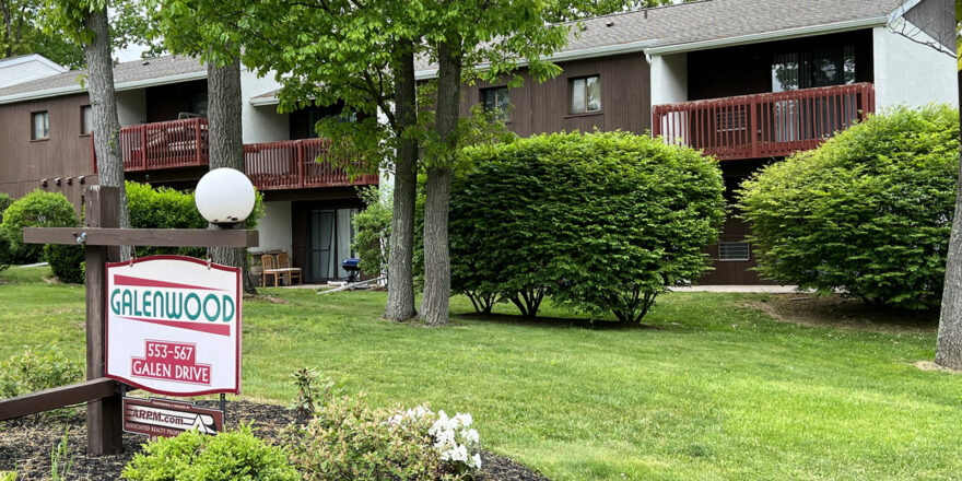 Galenwood sign in front of the brown and white building with red-brown painted balconies