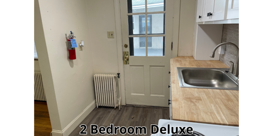 a kitchen with a stove top oven next to a sink