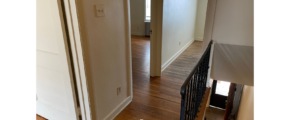 a hallway leading to a bedroom in a house