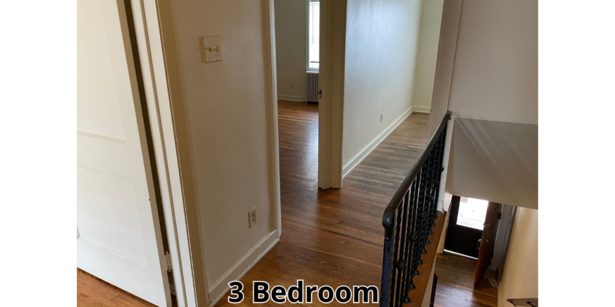 a hallway leading to a bedroom in a house