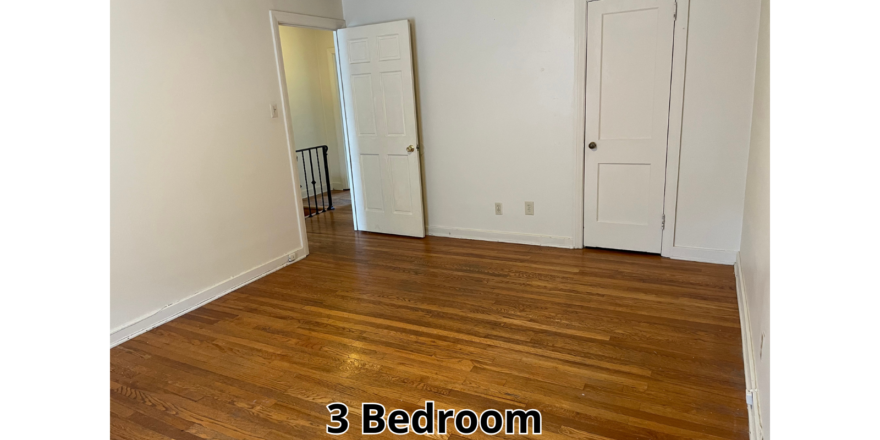 an empty room with wood floors and white walls