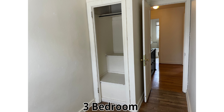 an empty room with a closet and a door