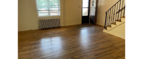an empty living room with hard wood floors
