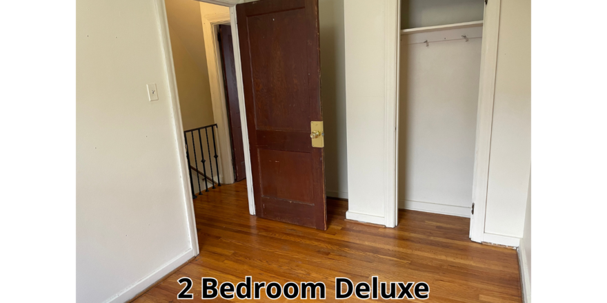 an empty room with a door and a closet