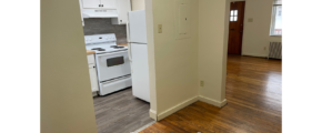 a kitchen with a stove top oven next to a doorway