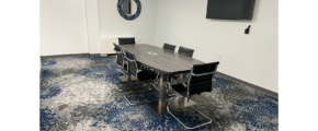 a conference room with a large table and chairs