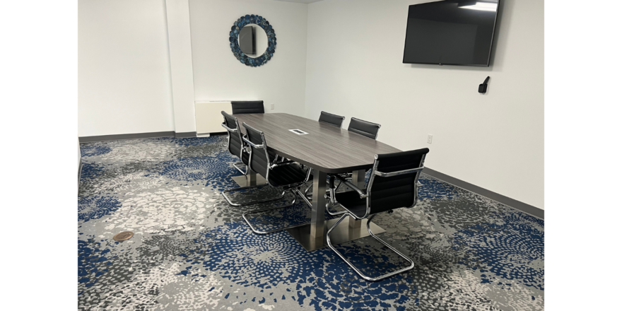 a conference room with a large table and chairs