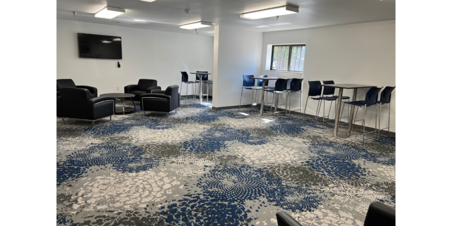 a large room with chairs and a flat screen tv