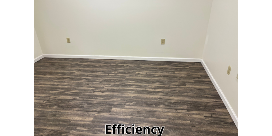 an empty room with a wood floor and white walls