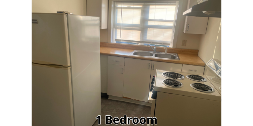 a kitchen with a refrigerator, stove and sink