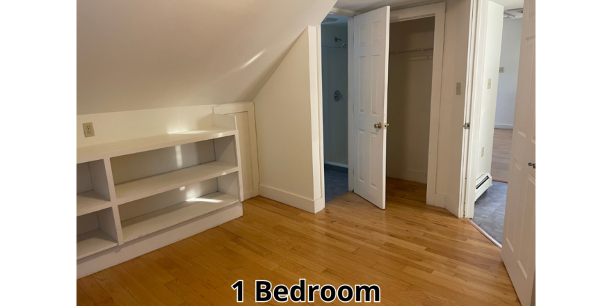 an empty room with a book shelf and a closet