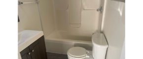 a bathroom with a toilet, sink, and bathtub