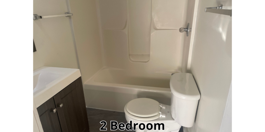 a bathroom with a toilet, sink, and bathtub