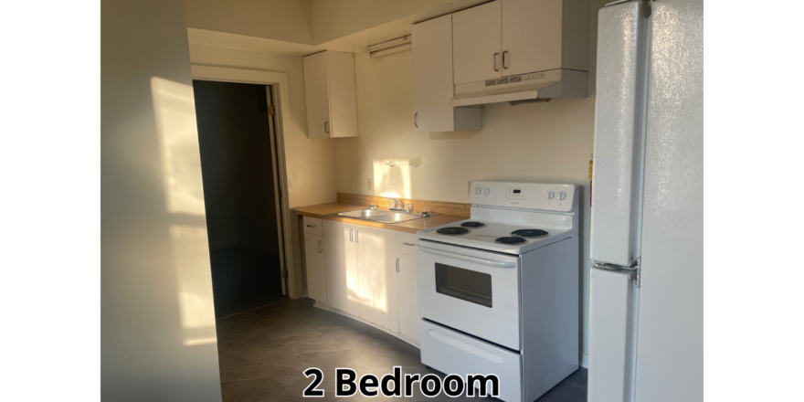 a kitchen with a refrigerator and a stove