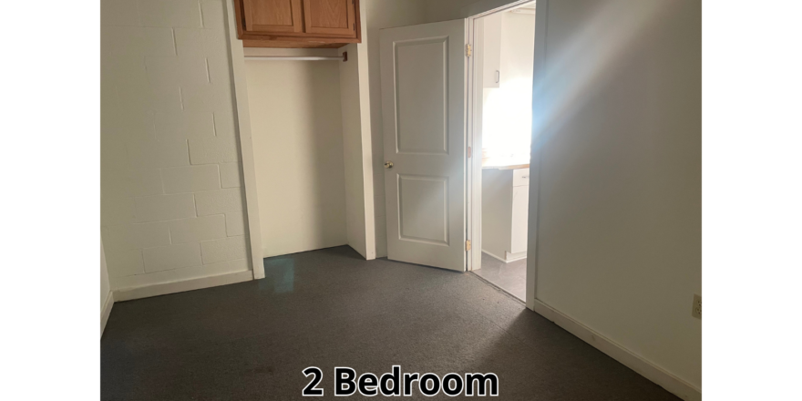 an empty room with a door and a window