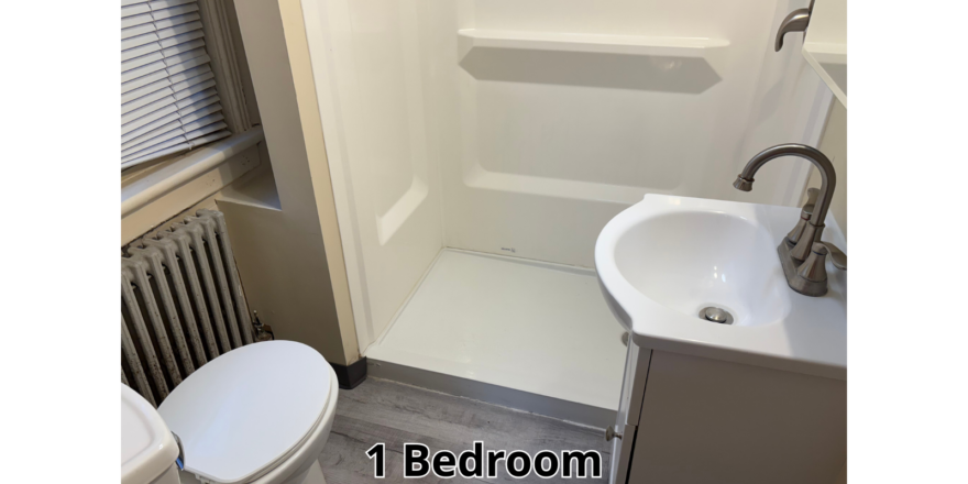 a bathroom with a toilet, sink, and shower