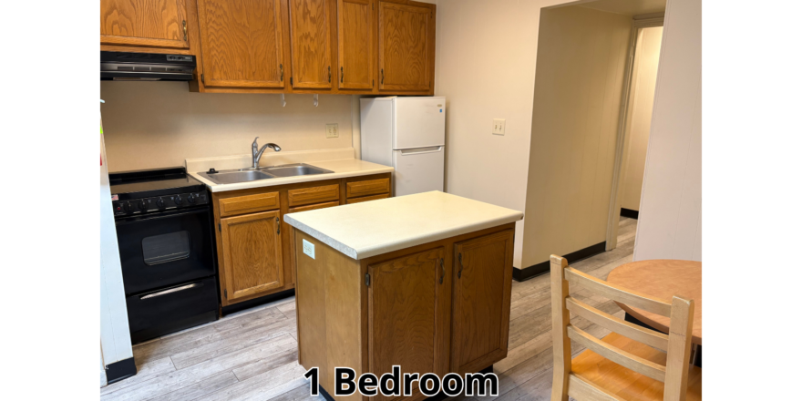 a kitchen with a table and a refrigerator