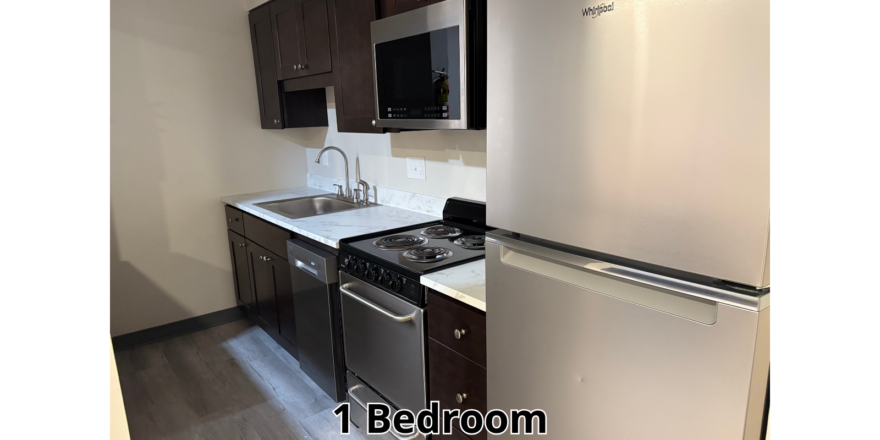 a kitchen with a refrigerator, stove, sink and microwave