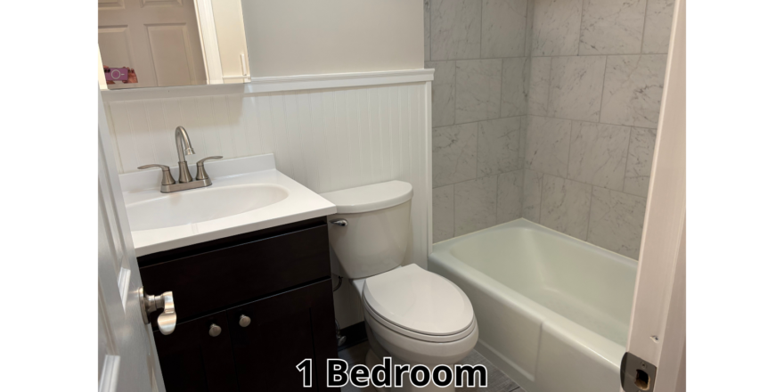 a bathroom with a toilet, sink, and bathtub