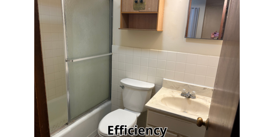 a bathroom with a toilet, sink, and shower