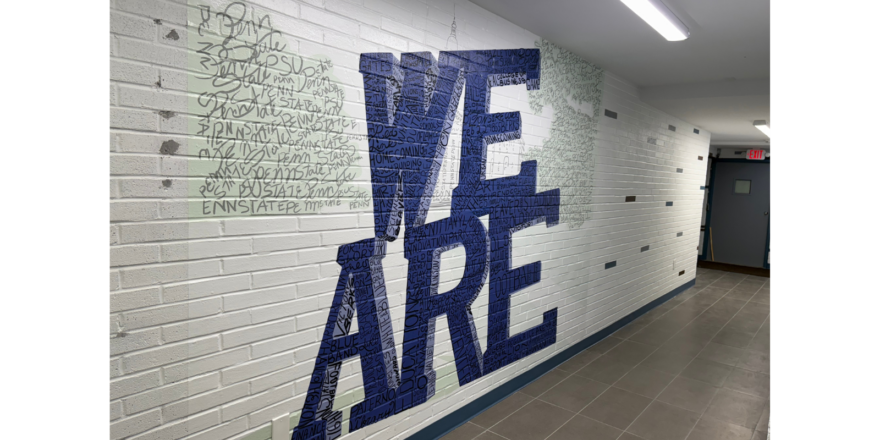 brick wall with blue WE ARE mural