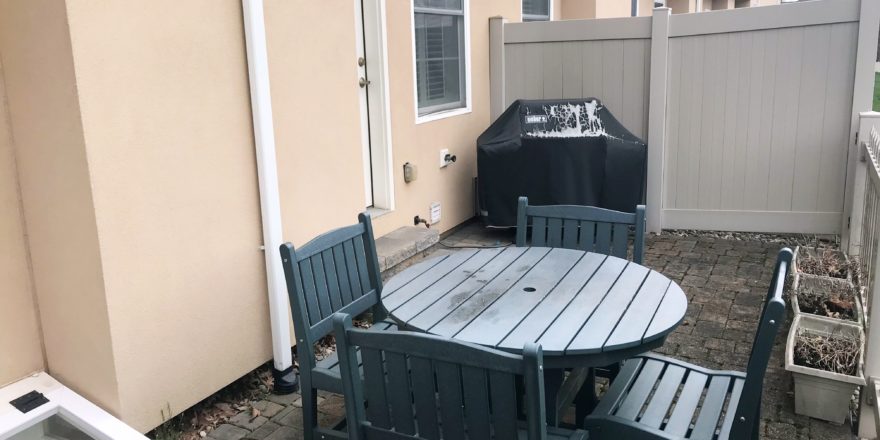 Fenced-in patio with furniture and grill