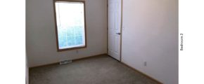 Unfurnished, carpeted bedroom with closet and a window