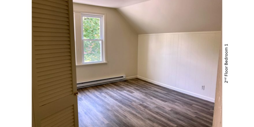 Bedroom with ceiling light and large window
