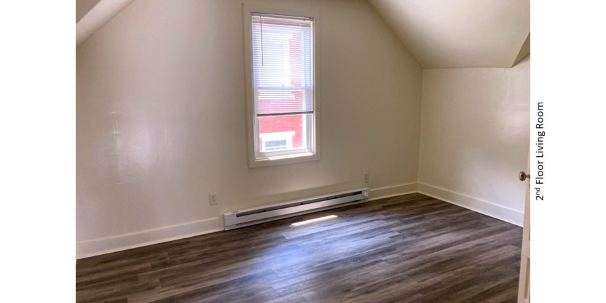 Living Room with sloped ceilings and window