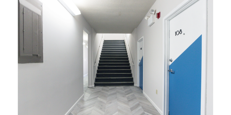 Hallway with stairway and doors