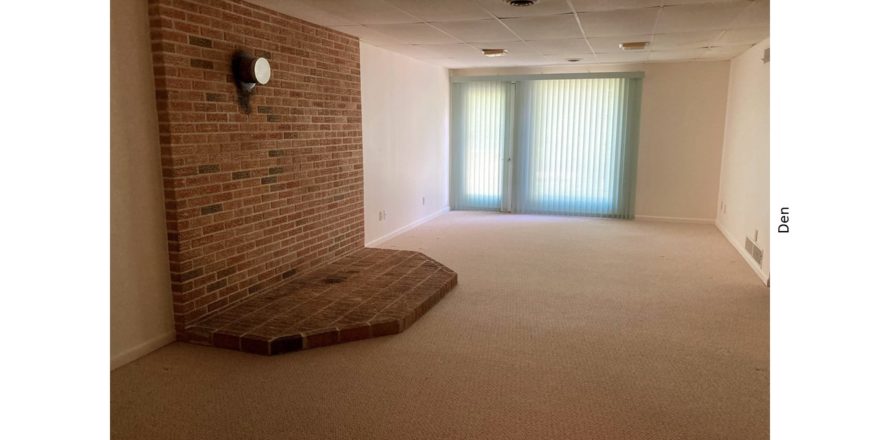 Den with brick hearth and drop ceiling