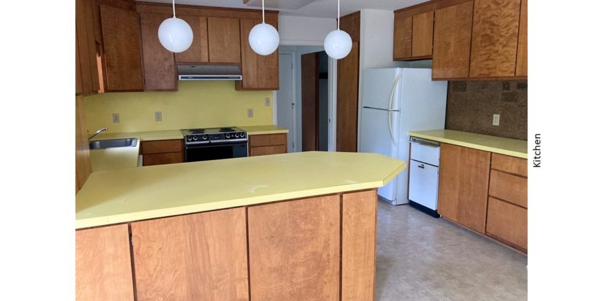 Kitchen with yellow countertops, wood-tone cabinets and appliances
