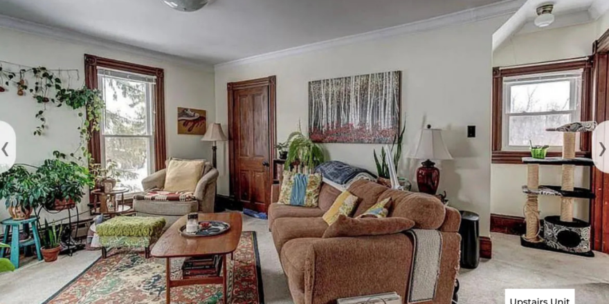 a living room filled with furniture and lots of windows