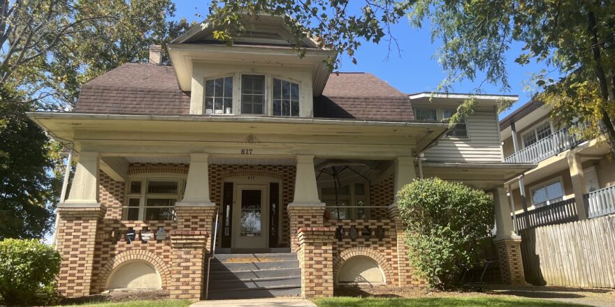 a brick house with a large front porch