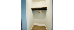 an empty closet space with no doors, a shelf and hanger rack