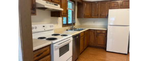 a kitchen with white appliances and wooden cabinets