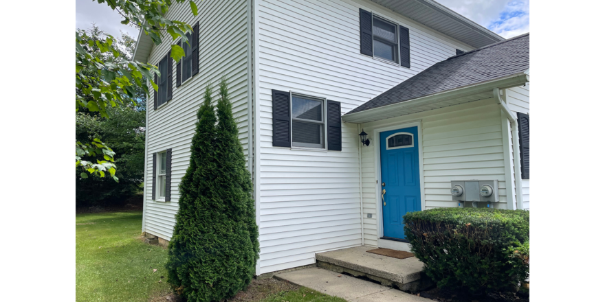 a white house with a blue door