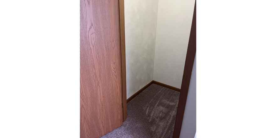 a door is open in a small closet
