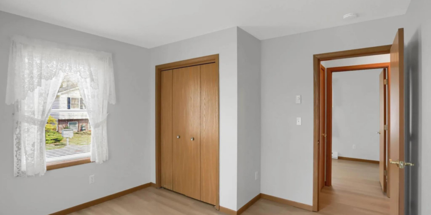 a empty room with a door and a window