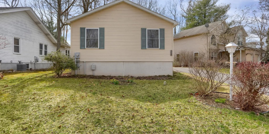 a small house with a yard in front of it
