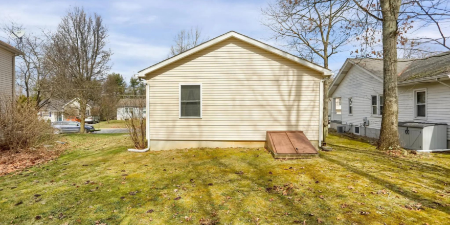 a small house with a yard in front of it