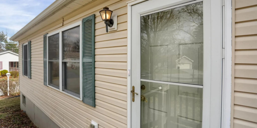 a house with a white front door and green shutters
