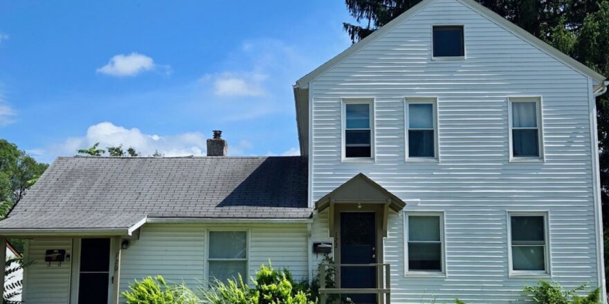 a large white house with a black roof