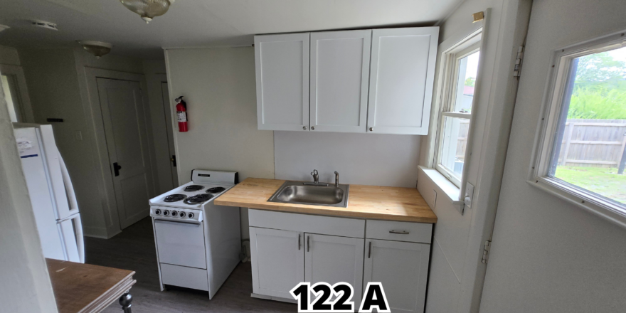 a kitchen with a sink, stove and refrigerator