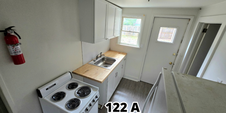 a kitchen with a stove top oven next to a refrigerator