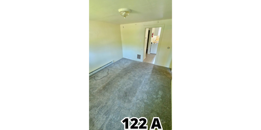 an empty room with a door and a window