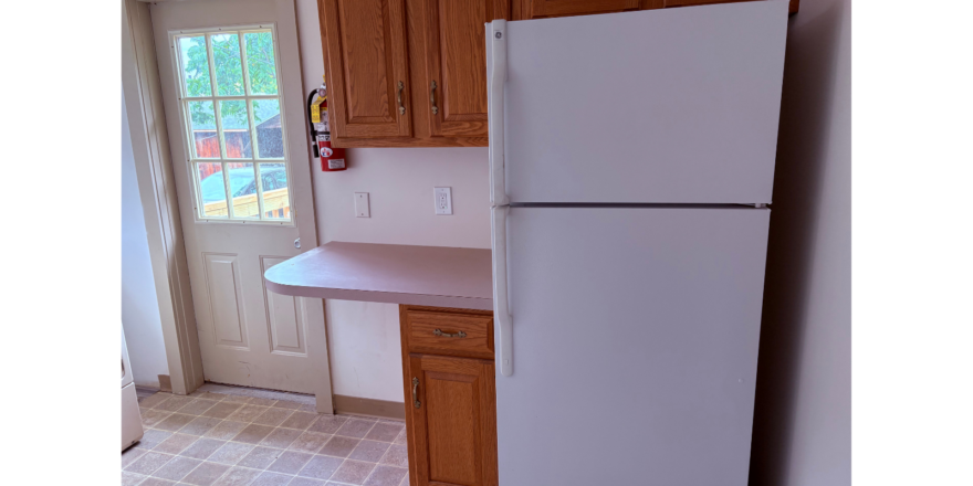 a white refrigerator freezer sitting inside of a kitchen
